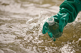 Scientists taking water samples from a river.